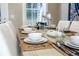 Formal dining table set with elegant dishware and coastal-themed decor for a luxurious dining experience at 211 65Th St, Holmes Beach, FL 34217