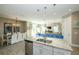 Spacious kitchen open to the dining and living areas, features an island with seating and granite countertops at 211 65Th St, Holmes Beach, FL 34217