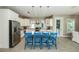 Modern kitchen featuring stainless steel appliances, granite countertops, and seating at the island at 211 65Th St, Holmes Beach, FL 34217