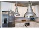Modern kitchen with stainless steel appliances, granite countertops, and contemporary pendant lighting at 211 65Th St, Holmes Beach, FL 34217