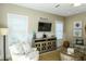 Cozy living room with beach decor, modern entertainment center, and comfortable armchair with starfish pillows at 211 65Th St, Holmes Beach, FL 34217