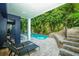 Inviting pool area with lounge chairs, stone steps, and waterslide, surrounded by tropical foliage at 211 65Th St, Holmes Beach, FL 34217