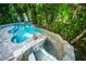 Pool with waterside, surrounded by greenery, offers a serene and private backyard oasis at 211 65Th St, Holmes Beach, FL 34217