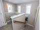 Bright staircase landing area with natural lighting, wood railing, and decorative wall art at 211 65Th St, Holmes Beach, FL 34217