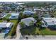 Aerial view of coastal home with driveway surrounded by lush landscaping and neighboring houses at 221 85Th St, Holmes Beach, FL 34217
