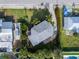 An aerial view shows the property and surrounding area from above showcasing the home and landscaping at 221 85Th St, Holmes Beach, FL 34217