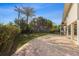 Spacious backyard featuring a paver patio and mature landscaping with trees and bushes at 221 85Th St, Holmes Beach, FL 34217