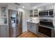 Well-lit kitchen featuring stainless steel appliances and ample storage space at 221 85Th St, Holmes Beach, FL 34217