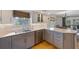 A kitchen showcases white countertops, gray cabinets, and stainless steel appliances at 221 85Th St, Holmes Beach, FL 34217