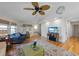 Living room with wood floors, a vaulted ceiling, and comfortable sofas; a staircase leads to the upper level at 221 85Th St, Holmes Beach, FL 34217