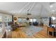 A comfortable living room with light hardwood floors, a ceiling fan, comfortable seating and lots of light at 221 85Th St, Holmes Beach, FL 34217