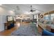 The living room connects to an open space in the back of the home, features hardwood floors and bright lighting at 221 85Th St, Holmes Beach, FL 34217