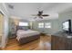 Inviting primary bedroom featuring hardwood floors and coastal decor at 221 85Th St, Holmes Beach, FL 34217
