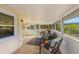 Screened-in patio with comfortable seating area, tile floor, and views of the outdoor scenery at 221 85Th St, Holmes Beach, FL 34217