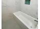 Modern bathtub with new marble tiled walls, shower head, and mosaic accent wall insert at 2477 Wood Oak Dr, Sarasota, FL 34232