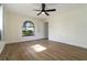 Spacious bedroom features a ceiling fan and a large window offering views of the surrounding greenery at 2477 Wood Oak Dr, Sarasota, FL 34232