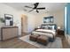 Well-decorated bedroom has a ceiling fan, and is furnished with neutral toned furniture and décor at 2477 Wood Oak Dr, Sarasota, FL 34232