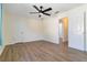 A spacious bedroom features a ceiling fan, light colored walls, and wood look flooring at 2477 Wood Oak Dr, Sarasota, FL 34232