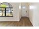 Entryway featuring wood-look flooring, a large window, and a white front door at 2477 Wood Oak Dr, Sarasota, FL 34232