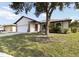 Single-story house showing garage, front door, front lawn, and landscaping at 2477 Wood Oak Dr, Sarasota, FL 34232