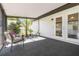 Enclosed lanai featuring an outdoor ceiling, neutral carpet, and furniture at 2477 Wood Oak Dr, Sarasota, FL 34232