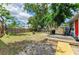 Spacious backyard with a fire pit, deck, and lush greenery at 2509 8Th W Ave, Bradenton, FL 34205