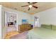 Bedroom showing a wood dresser, ceiling fan, and door leading to the living room at 2509 8Th W Ave, Bradenton, FL 34205