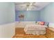 Light blue bedroom featuring a ceiling fan and white wainscotting at 2509 8Th W Ave, Bradenton, FL 34205
