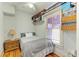 Bright bedroom with a cozy bed, wooden floors, and shelves for storage above the window at 2509 8Th W Ave, Bradenton, FL 34205