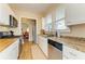 Bright kitchen with wood floors, stainless steel appliances, and window above sink at 2509 8Th W Ave, Bradenton, FL 34205