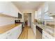 Efficient kitchen with white cabinets, granite countertops, modern appliances, and bright natural light at 2509 8Th W Ave, Bradenton, FL 34205