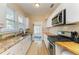 Bright kitchen features stainless steel appliances, wood countertops, and double window at 2509 8Th W Ave, Bradenton, FL 34205