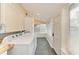 Bright laundry room featuring modern appliances, tile flooring, and natural light at 2509 8Th W Ave, Bradenton, FL 34205