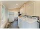 Functional laundry room with appliances, storage cabinets and plenty of natural light at 2509 8Th W Ave, Bradenton, FL 34205