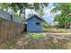Exterior view of blue shed featuring a door and a window in a fenced backyard at 2509 8Th W Ave, Bradenton, FL 34205