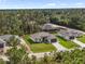 An aerial shot showcases the home and its wooded surroundings at 2638 Hagerick Ln, North Port, FL 34288