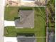 Aerial view of a modern single-story home with a well-manicured lawn and private backyard at 2638 Hagerick Ln, North Port, FL 34288