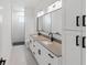 Bathroom featuring double sink vanity and a walk-in shower at 2638 Hagerick Ln, North Port, FL 34288
