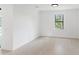 Bright bedroom with a large window and neutral color palette at 2638 Hagerick Ln, North Port, FL 34288