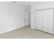 A clean bedroom featuring neutral flooring, a closet and doors at 2638 Hagerick Ln, North Port, FL 34288