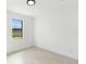 This bright bedroom features a large window and sleek flooring at 2638 Hagerick Ln, North Port, FL 34288