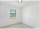Bedroom with tile flooring, neutral color palette, and a large window at 2638 Hagerick Ln, North Port, FL 34288