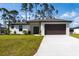 Charming single-story home featuring a manicured lawn, neutral paint scheme, and an attached two-car garage at 2638 Hagerick Ln, North Port, FL 34288