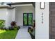 Elegant front entrance with double doors, manicured landscaping, and contemporary exterior lighting fixtures at 2638 Hagerick Ln, North Port, FL 34288