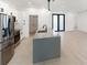 Modern kitchen with stainless steel appliances and large center island at 2638 Hagerick Ln, North Port, FL 34288