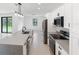 Modern kitchen featuring stainless steel appliances, a central island, and ample cabinet space at 2638 Hagerick Ln, North Port, FL 34288