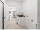 Bright laundry room with sink and modern fixtures at 2638 Hagerick Ln, North Port, FL 34288