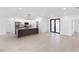 Bright open-concept living area with tile flooring and modern kitchen featuring a stylish island at 2638 Hagerick Ln, North Port, FL 34288
