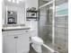 Clean bathroom features a tiled shower, vanity, toilet and decorative shelving at 3162 27Th E Ct, Palmetto, FL 34221