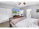 Spacious bedroom with walk-in closet, ceiling fan, plush carpet and mounted television at 3162 27Th E Ct, Palmetto, FL 34221